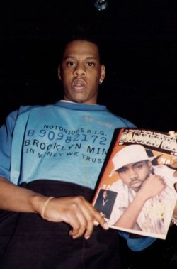 trakkbastards:  femaledominationnation:  The irony.  JiggaWearin a Biggie shirtHolding a Nas magazine pic With Tupac in the caption picture Please show me a more accidental greatest pic in hip hop ever 