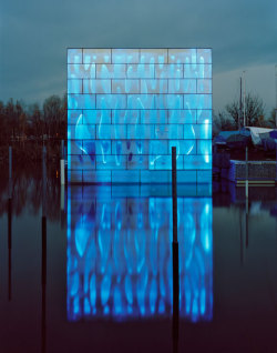 rustybreak:  Nordwesthaus by Baumschlager Eberle.This cool modern design rises 14 meters out of the water as a glowing glass cube, illuminated by an ever-changing display of LED color sequences that go from green, to blue, yellow, to red before your eyes.