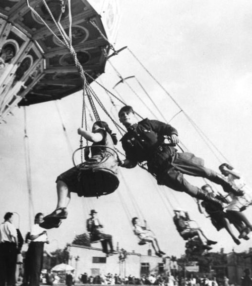 legrandcirque:An off duty Soviet soldier on a flying swing at Parter Park. Photograph by Dmitri Kess