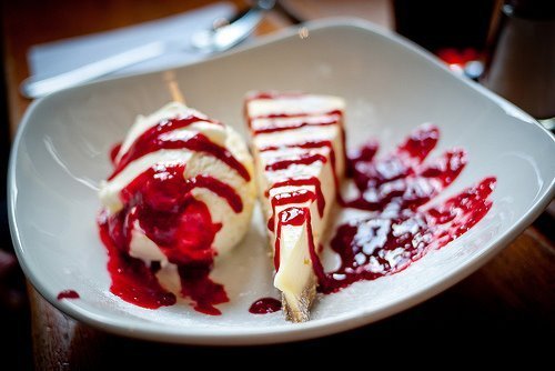 Cheesecake with Strawberry Drizzle and Vanilla Ice Cream