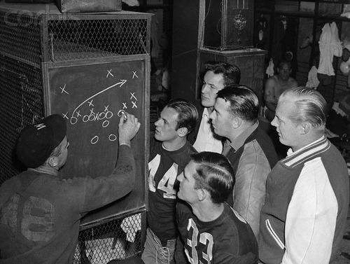 Coach Ray Flaherty of the Washington Redskins, plotting plays on theblackboard, during a “skull dril