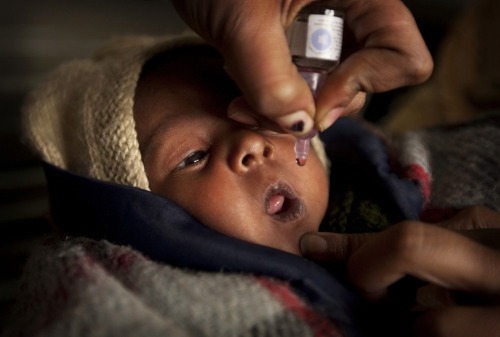 A health worker administers a polio drop to a newborn baby at Chacha Nehru Bal Chikitsalaya in New D