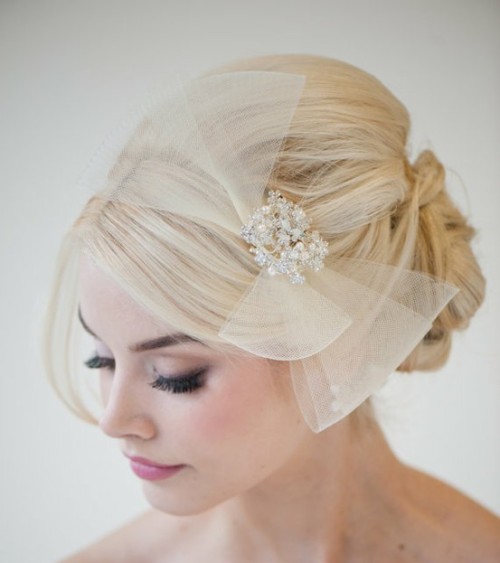 This has to be one of my favorite bridal head pieces. It’s different, inspired by the 40s, and affordable. Powder Blue Bijoux has stunning headpieces, veils and accessories. Check it out!