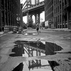 black-and-white:  puddles tell the story (by Barry Yanowitz) 