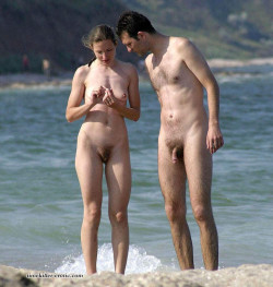 nudistlifestyle:  Nudist couple at the beach. I think she has a sore finger !  o kiss it better