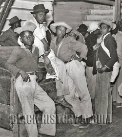 Teens waiting to get paid for cotton picking inside Marcella Plantation’s store on Friday night, Mileston, Mississippi, 1939.