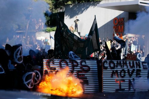 Oakland Police firing flashbang grenades at protesters during the J28 march yesterday.