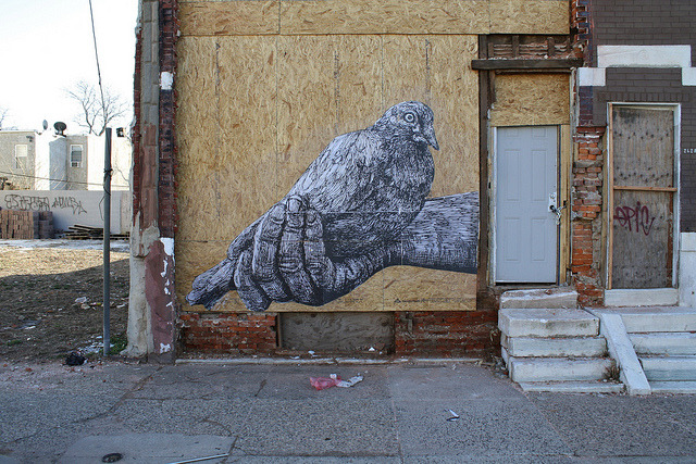 Carrier Pigeon Held Inwards by gaia.streetart on Flickr.