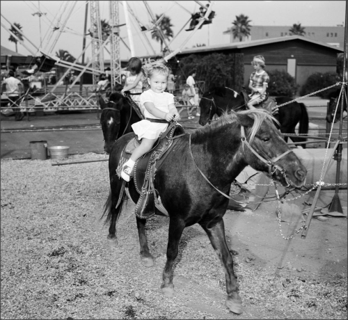 Pomona Fair, 1951Kids and adults alike enjoy the fun entertainment at the county fair. Some of the f