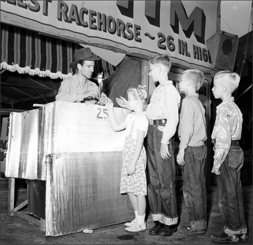 Pomona Fair, 1951Kids and adults alike enjoy the fun entertainment at the county fair. Some of the f