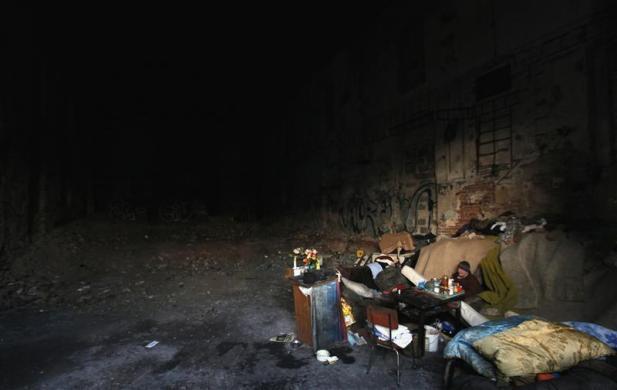 Prague, Czech Republic
A homeless woman sits in an abandoned factory which serves as a shelter for homeless people in the city’s Vysocany district (via Reuters.com)