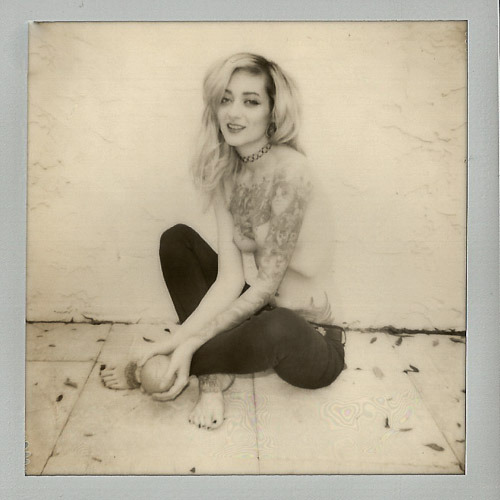 Black and white, with an orange. Polaroid by David Hilton, model Theresa Manchester