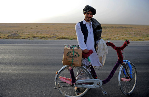 landoftheafghan: An Afghan man stops to pose for a photo while riding his bicycle along Highway 1 in