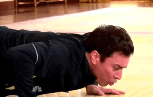 Jimmy Fallon attempting to do push-ups.