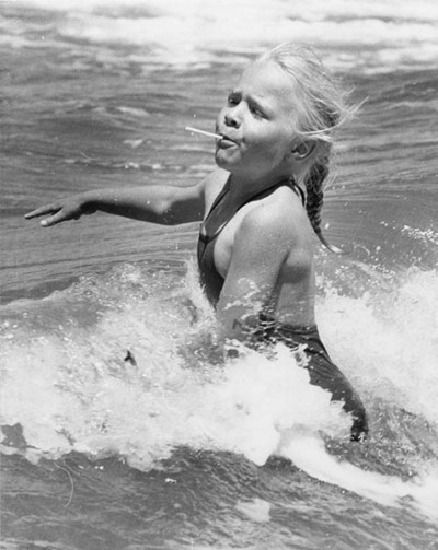 Joanne Beatty, 5, of Weetangera enjoys a dip and a lollipop at the YMCA holiday camp at Long Beach, Batemans Bay
1978