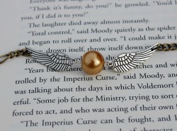 lulz-time:  Harry Potter Golden Snitch Bracelet, sold at the Wicked Clothes shop. Order now and use coupon code ‘1000NOTES’ to get 10% off your ENTIRE order! Click here to go to the shop! 