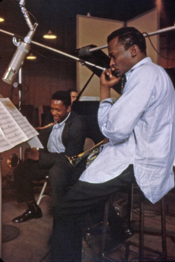 tornandfrayed:  A laughing (!) John Coltrane and a pensive Miles Davis.
