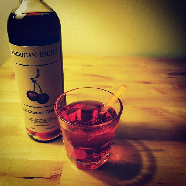 Here’s a tasty beverage I’m calling Hope Rides Alone: one part sour cherry cordial, two parts vodka, tonic to taste, and a single cherry. (I used an Ole Smoky Moonshine cherry, but any cherry will do.)
Many red cocktails get their color from...