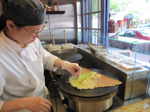 Patricia from Fresca la Crepe (39-82, 61 St) in Woodside. I love the way she runs her shop. Here she is performing one of her signature twists that make her crepes so good: crisping cheese on the griddle. Act like you’re in-the-know and order the...