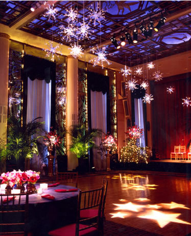 Beautifully lit wedding venue: hanging snowflake lights, gobo star lighting on the dance floor, tabl