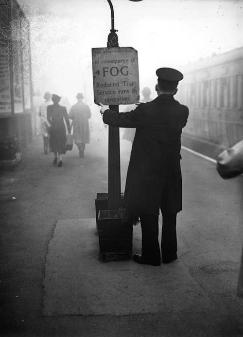 luzfosca:  A rail worker fixing a fog warning notice at South Woodford Railway Station in Essex, 20th October, 1938. H. F. Davis/Topical Press Agency/Getty Images 