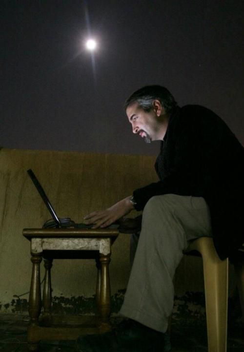 Former Washington Post foreign correspondent Anthony Shadid (1968-2012) files by moonlight and satellite modem on a hotel rooftop in Najaf, Iraq.
Obituary | Remembrances | Photos | His Pulitzer-winning work
Photo by Bill O'Leary (The Washington Post)