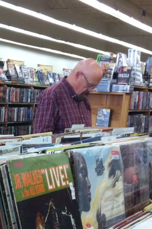 Walter White sifting through comics at Half Price Books.