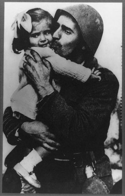 Thevirussickness:  A Greek Soldier Holding His Little Daughter In His Arms 