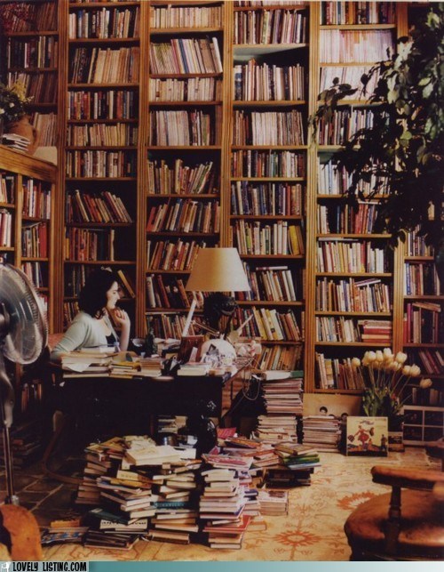 ohhelloholly:as if i didn’t already love nigella enough.sweet bookcase, girl.