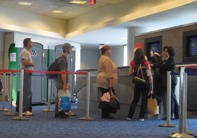  In an American airport a strange looking young couple arrived to travel to Las Vegas.