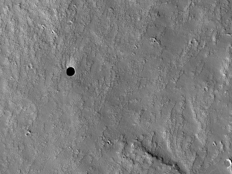 n-a-s-a:  A Hole in Mars  Credit: NASA, JPL, U. Arizona Explanation: Black spots