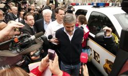 washingtonpoststyle:  George Clooney is arrested this morning after protesting at the Sudan Embassy in Washington, D.C. Live updates here. Photo by Kevin Lamarque (Reuters) 