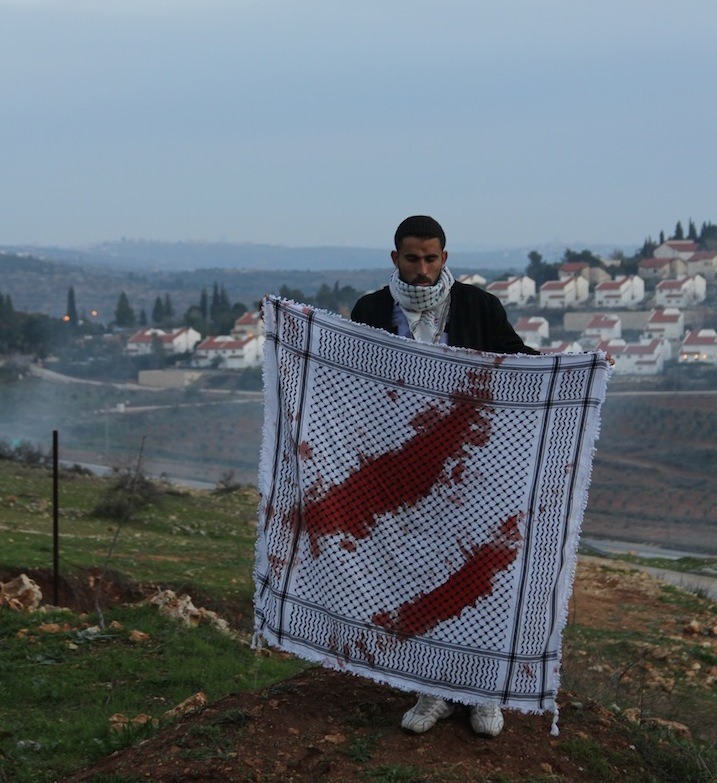 deemzbeamz:  ffirouzeh:  Palestinian activist holds blood-soaked kuffiyeh that French
