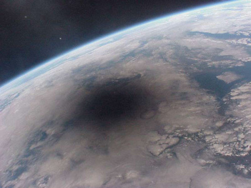 n-a-s-a:  Looking Back at an Eclipsed Earth  Credit: Mir 27 Crew; Copyright: CNES 