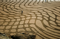 San Francisco-area landscape artist Andreas Amador etches massive sand drawings onto beaches during full moons when his canvas reaches its largest potential.