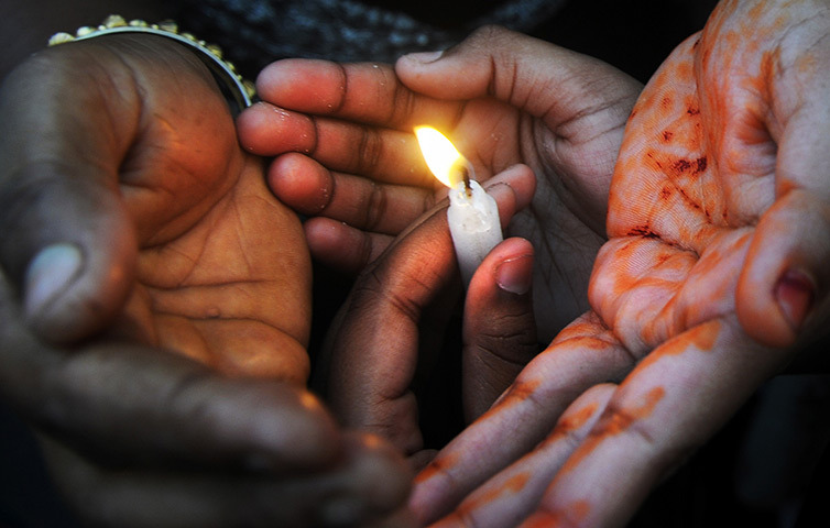 politics-war:  Women’s rights activists hold candles during a rally to protest