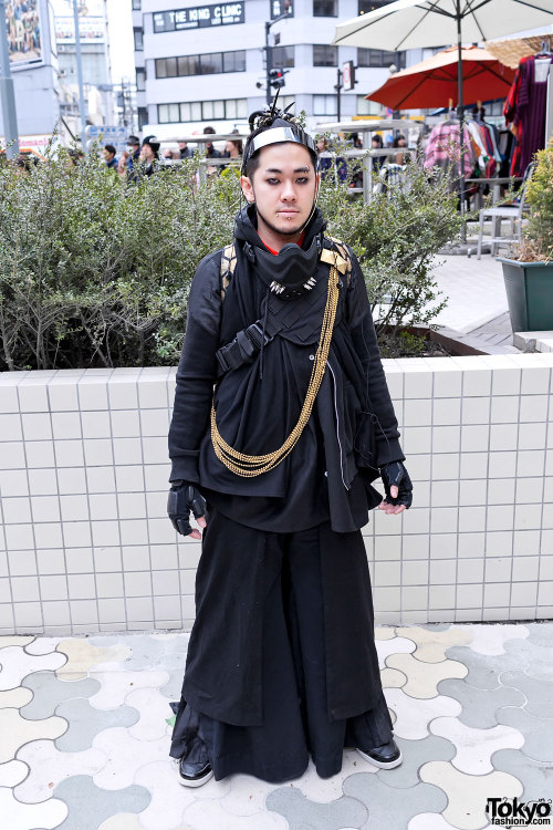 Japanese cyber goth/punk style guy with electrical-wire hair falls on the street in Harajuku.