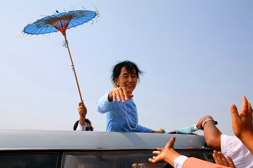 Supporters reach out to pro-democracy opposition leader Aung San Suu Kyi in Sagaing, Myanmar.