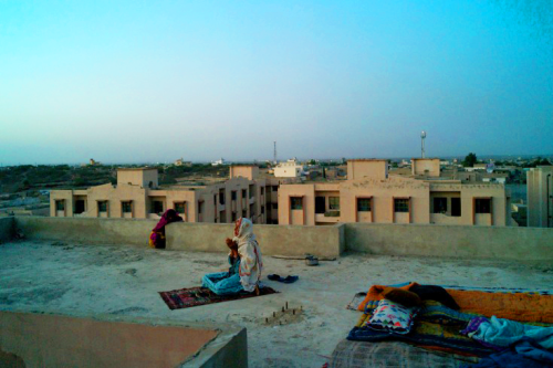 A woman says prayers on the rooftop of Karachi’s Labour Square Flats in Pakistan.