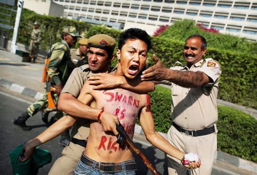 Police detain a Tibetan protestor during a demonstration against the visit of Hu Jintao in New Delhi