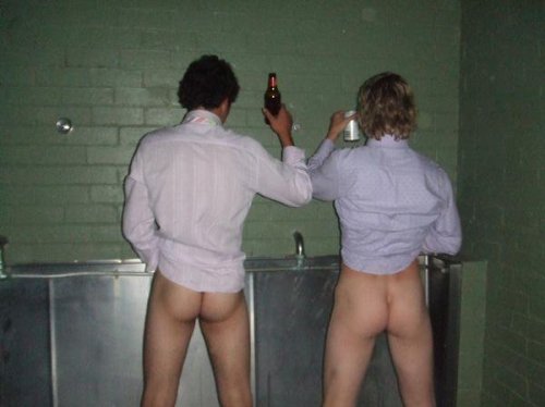 Drunk straight buddies, pissing at a urinal trough.