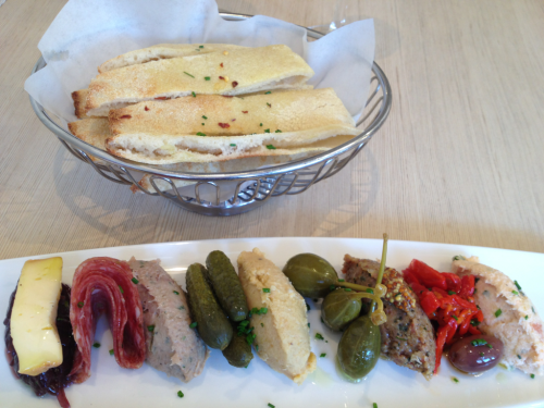 Deliciousness at Brabo Tasting Room in Old Town Alexandria: from left, caramelized onions with Chimay cheese, salami, duck rillette, cornichons, hummus, caper berries, salami rillette, roasted red peppers and salmon rillette.