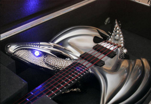samanfuu:  ianbrooks:  Chrome Dragon Bass Guitar by Emerald Guitars Created as a commission for a client in Thailand and meant to depict a dragon in midflight, it also contains glow-y blue LED eyes and a smaller dragon on the headstock. That’s double