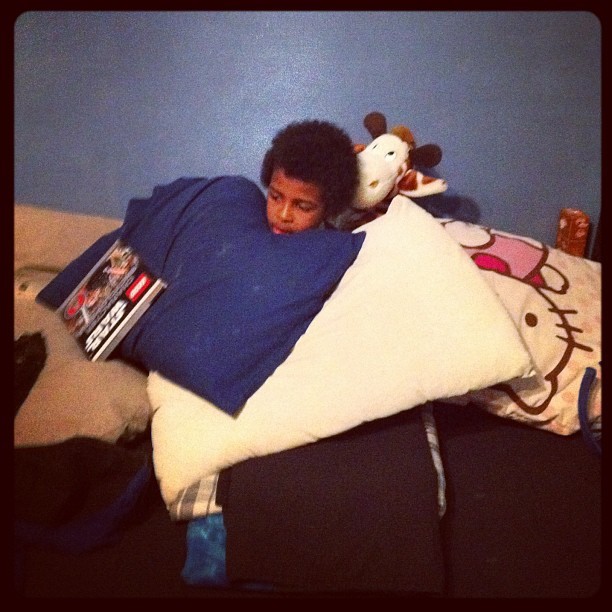 Amin covers himself in pillows while we watched the Young Justice series.  (Taken