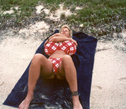 Via badbadb: Any day with Busty Dusty in a bikini is a sunny day. Here she is working on her tan lines.