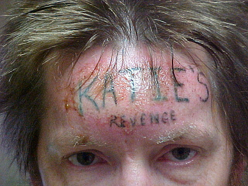 gelatinadeleche:  An inmate serving a life sentence for molesting and murdering a 10-year-old girl named Katie was forcibly tattooed across the forehead by a fellow prisoner with the words “KATIE’S REVENGE” 