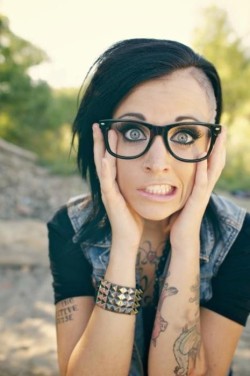 fyeahnoserings:  Blue-Eyed Girl With An Undercut (or Skrillex-Looking Haircut) Wearing A Nose Hoop, Glasses &amp; Tattoos Anyone else think this woman looks like the punk love child of Katy Perry &amp; Jenny McCarthy with a Skrillex haircut? No? Just