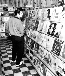 vintagegal:  Elvis in a record store in Memphis, 1957 