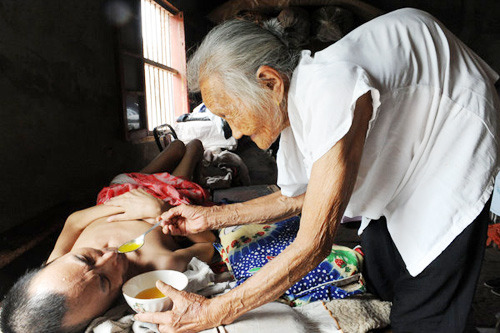  A mother (97 years old) in China, feeding and taking care of her paralysed son (60 years old) everyday for more than 19 years. A reminder of the amazing spirit of human compassion and more importantly, motherly love. 
