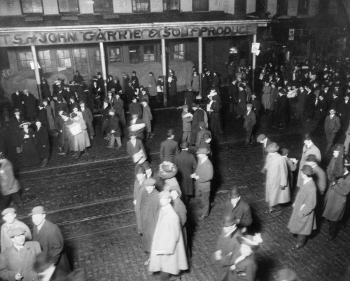 People stand on the street after the Titanic disaster, awaiting the arrival of the Carpathia. 